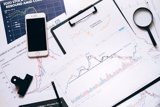 CMA Consultation <BR>Phase II Stock market analysis setup with charts, phone, magnifier, and clipboards.
