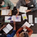 Overhead view of diverse professionals collaborating on a project in a modern office setting.