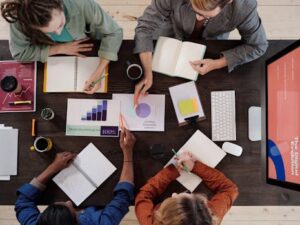 Overhead view of diverse professionals collaborating on a project in a modern office setting.